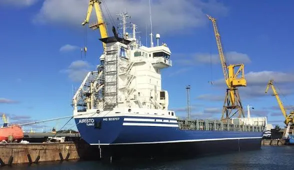 General cargo vessel Azarro alongside a quay with harbour cranes